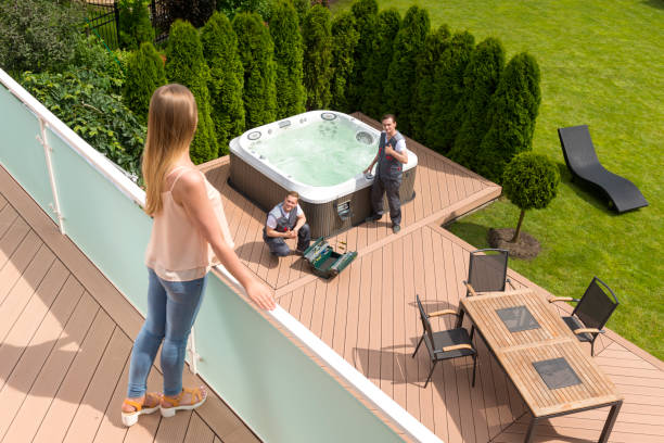 A young woman stands on the balcony and oversees the work of repairmen who fix the POOL.